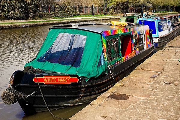 Clarence Mill (top left) is a former cotton spinning mill in Bollington, built in the 1830's - (top right and bottom) Colourful boats and a tree house along the Macclesfield canal.