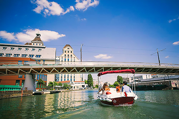 Electric boat hire on the Bassin de la Villette, Paris.