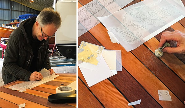 Tim Bird, our go-to sign writer, honing his craft in our boat store.