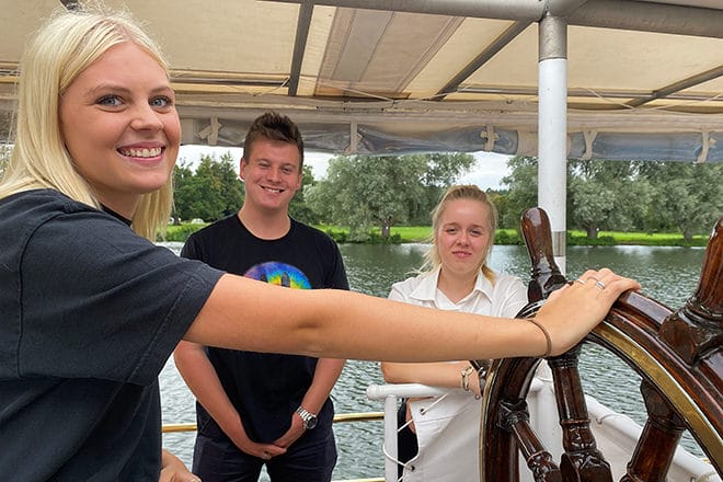 PureBoating staff crewing at the Henley Festival (en route to collect our guests from Hurley) - Olivia at the helm and James & Sasha on the port side.