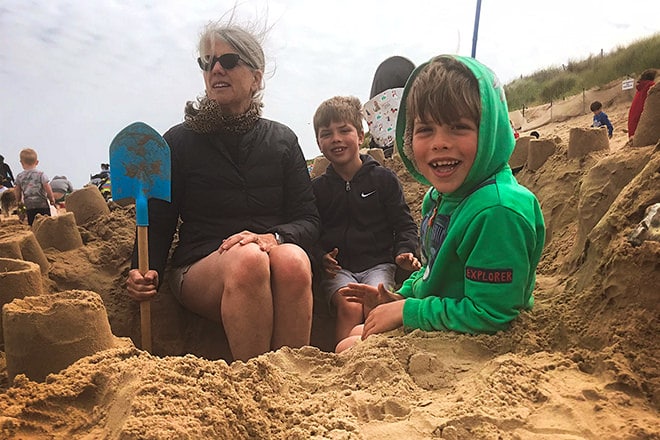 On the beach with my grandsons in our self-dug shelter.