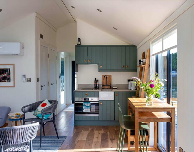 The Henley Houseboat cosy kitchen, dining area and saloon (hidden on the far left)