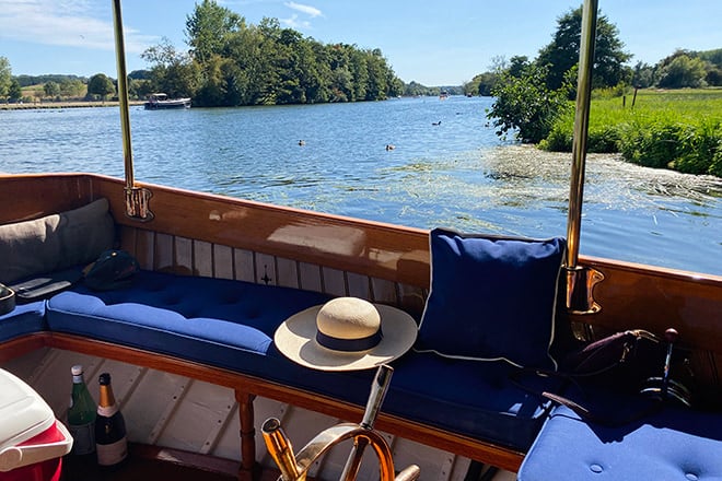 Life afloat on 'Spirit x' - sparkling wine and the river drifting gently by, the perfect setting for entertaining.